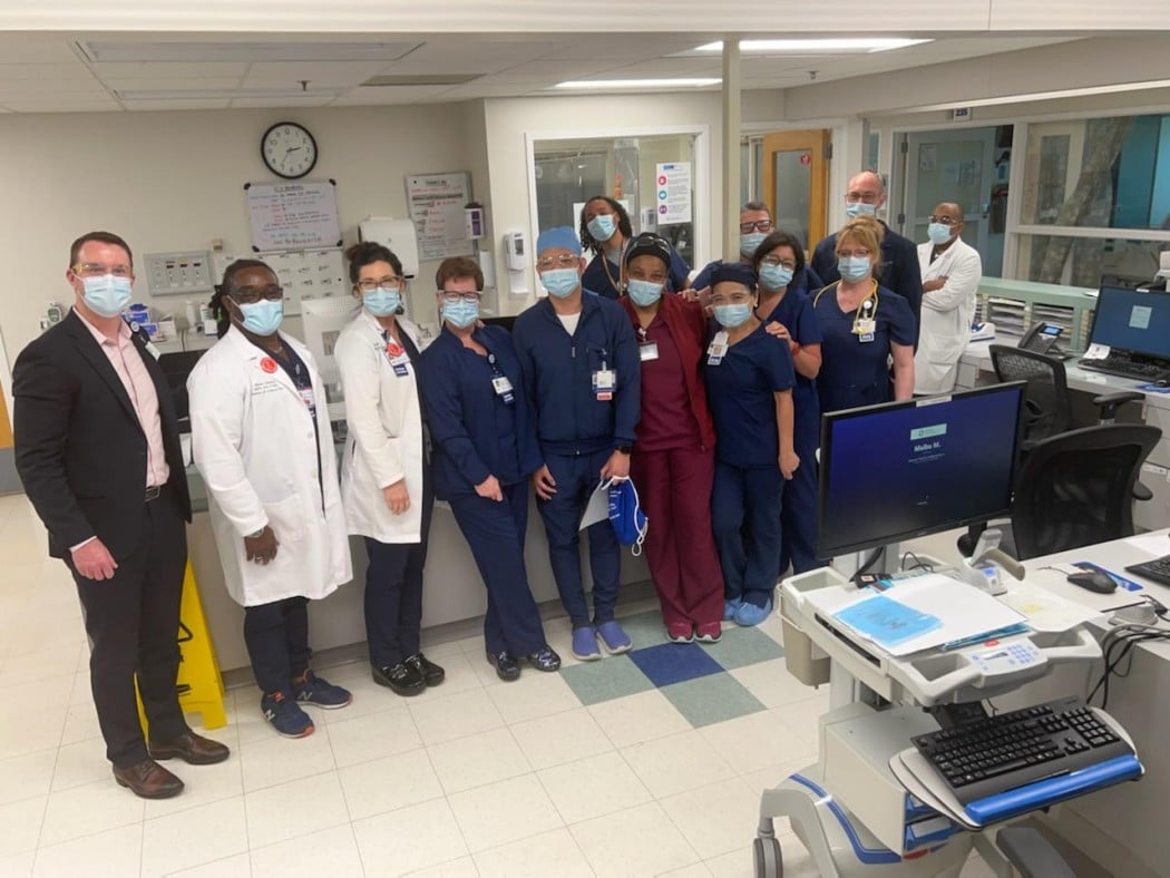 doctors and nurses pose in hospital area