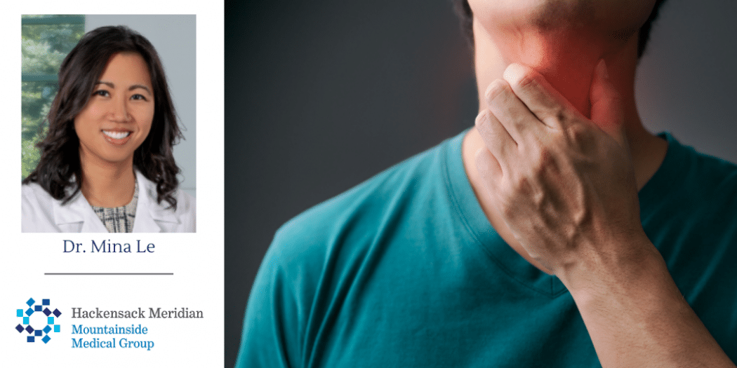 man rubbing his throat